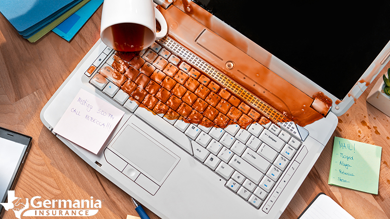 A ruined computer covered in spilled coffee emphasising the need for cloud storage.