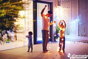 A father and his children safely decorating with Christmas lights