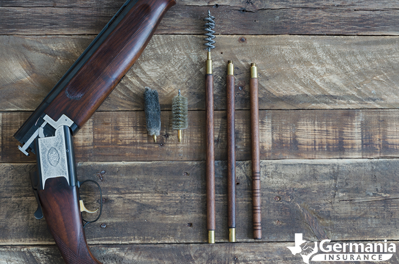 Firearm maintenance and gun cleaning kit next to a rifle