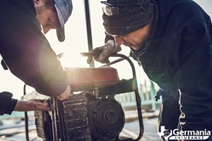 Two men operating a home generator.