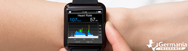 A fitness tracker displaying heart rate