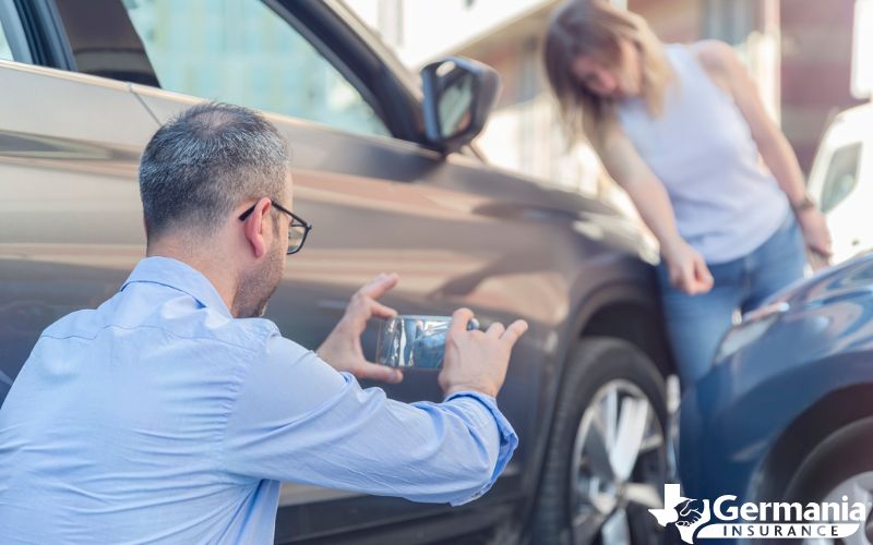 Man taking a photo of car accident