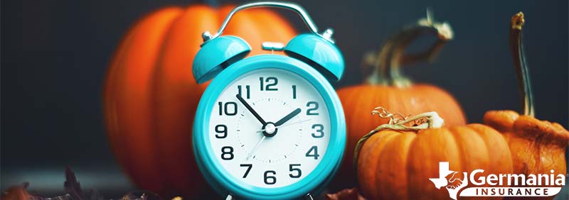 A clock with pumpkins symbolizing the end of daylight savings time in fall