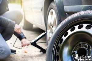 Going through the steps of how to change a flat tire