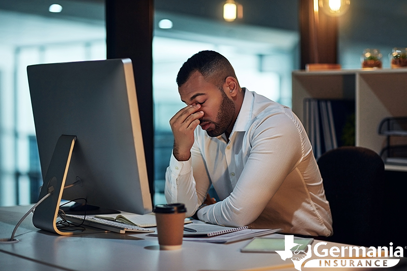 A man in front of a computer frustrated with password management.