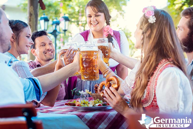 A group of people toasting with beer mugs at Oktoberfest in Texas