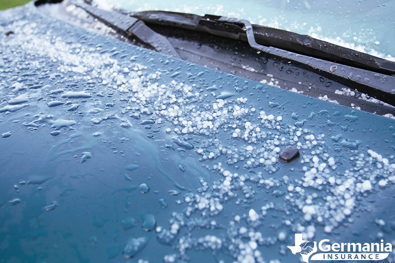 The hood of a car damaged by hail