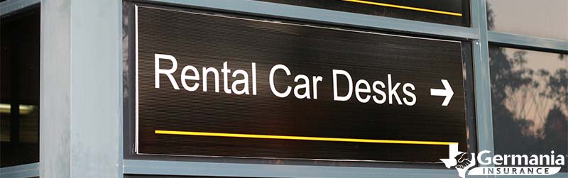 An airport sign pointing to rental car desk