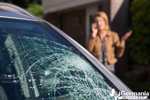 A woman considering whether to repair or replace her damaged windshield.