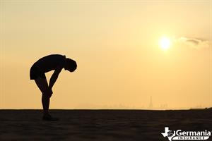 A silhouette of a man showing signs of heat stroke or heat exhaustion
