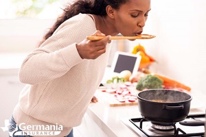 A woman tasting a Texas winter recipe