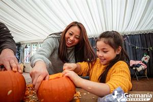Mother and daughter decorating pumpkins - fall activities in Texas