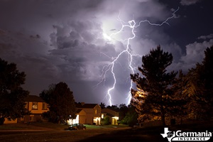 Lightning bolts flashing over a house