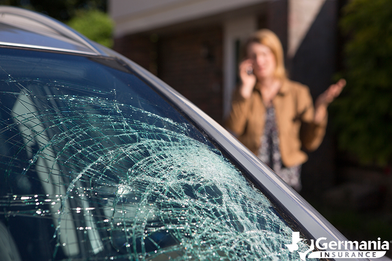 A woman with a cracked windshield that needs to be repaired or replaced